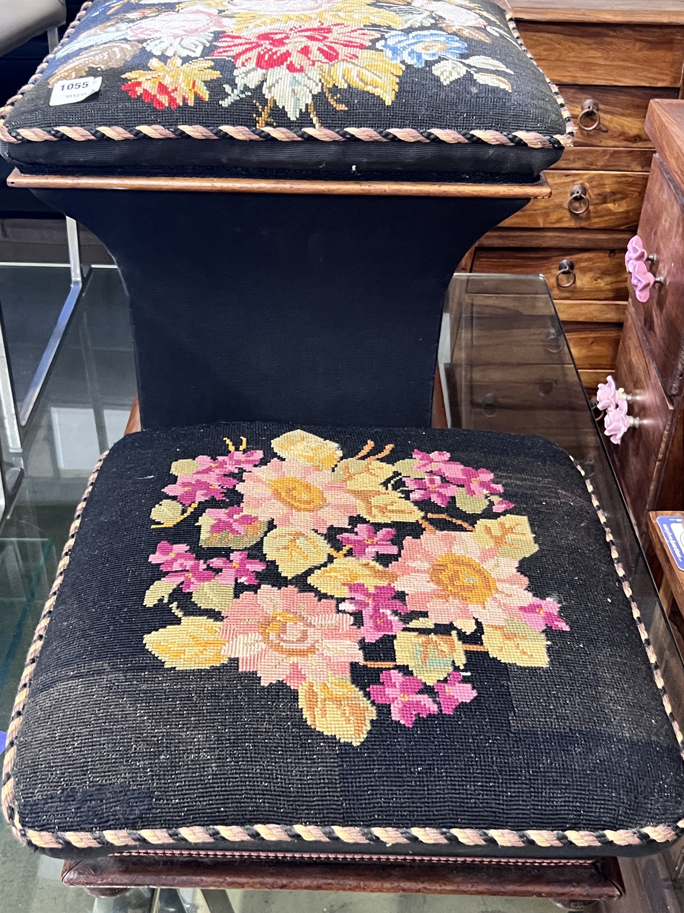 A Victorian ottoman stool with woolwork floral upholstery, width 48cm and a similar footstool, width 48cm